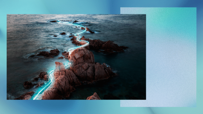 Rocky coastline with a digitally added glowing light path winding through the rocks and extending into the sea, contrasting with the natural landscape