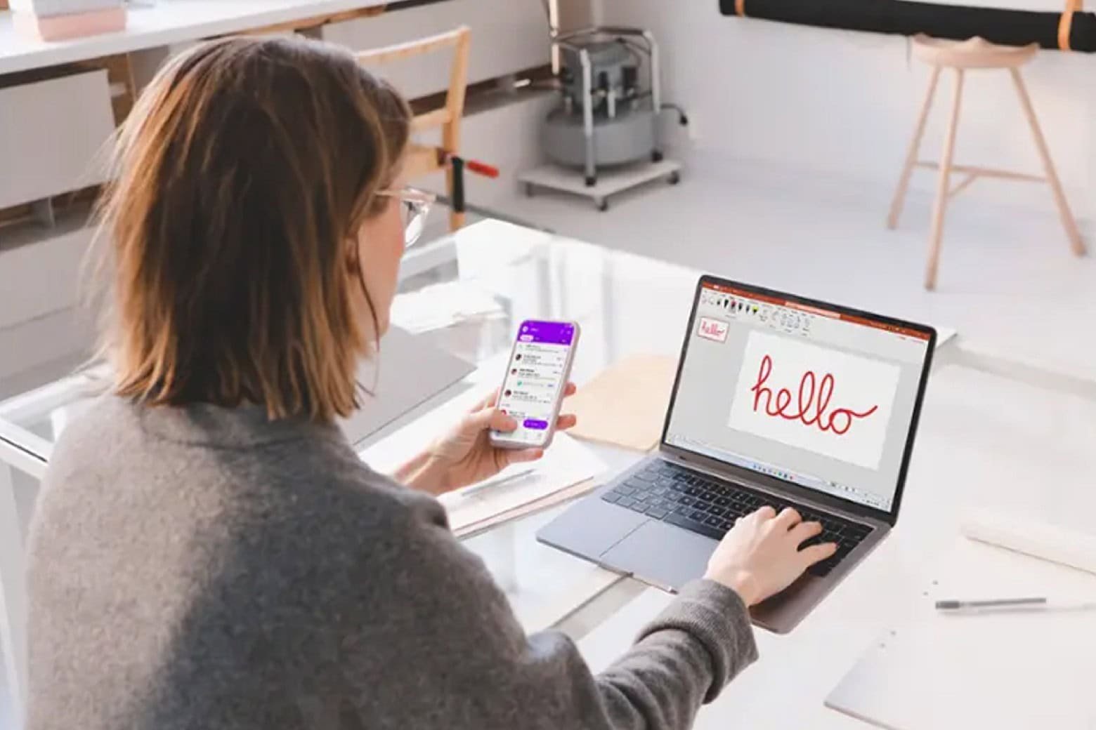 Woman using her laptop with one of Microsoft Office 2024 apps installed.